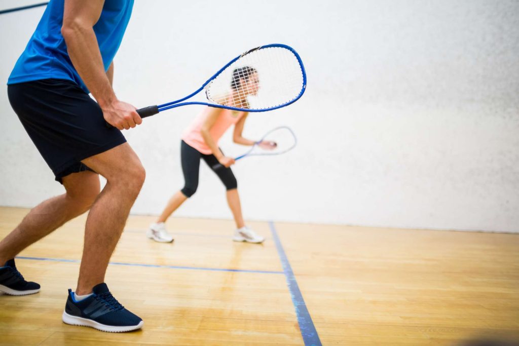 2 persons playing tennis together