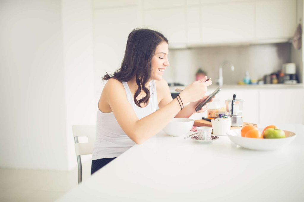 Woman eating a healthy meal while she's happy